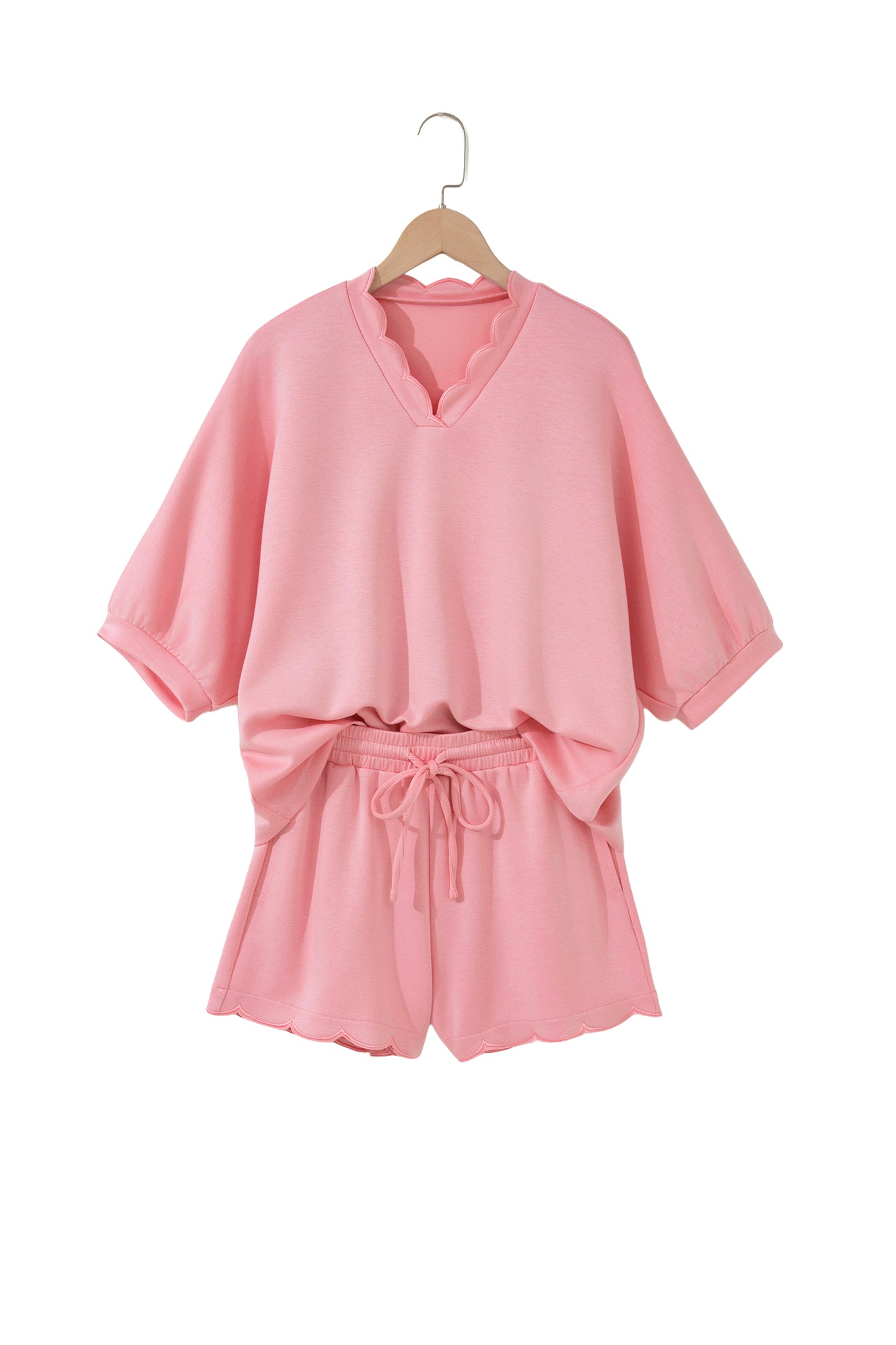 Conjunto de top tipo dolman oversize rosa con cuello en V festoneado y cordón ajustable