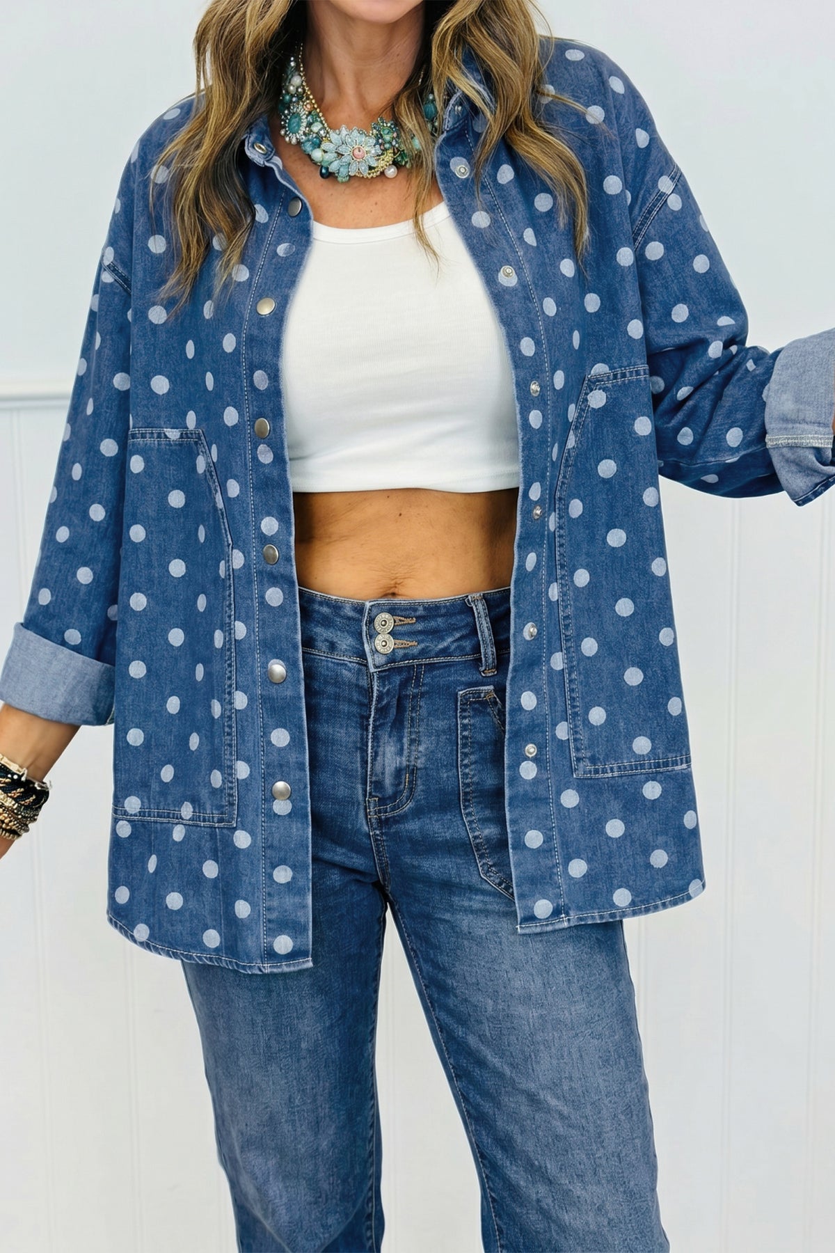 Chaqueta tipo túnica de mezclilla, corte recto, con cuello, manga larga y estampado de lunares azules.