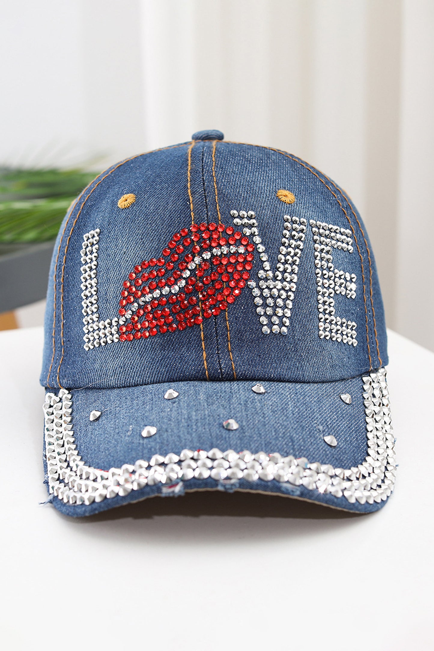Gorra de béisbol de mezclilla Ashleigh con diseño de labios y la palabra "LOVE" adornada con pedrería azul