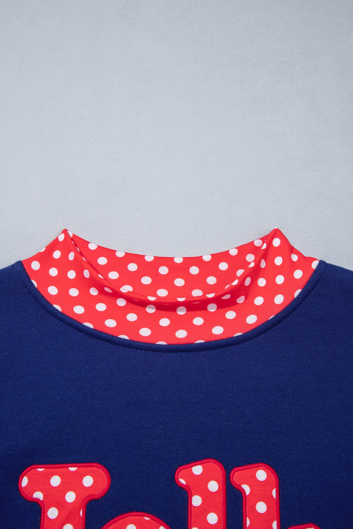 Sudadera rojo intenso con estampado de letras y lunares, cuello perkins y ribetes en contraste