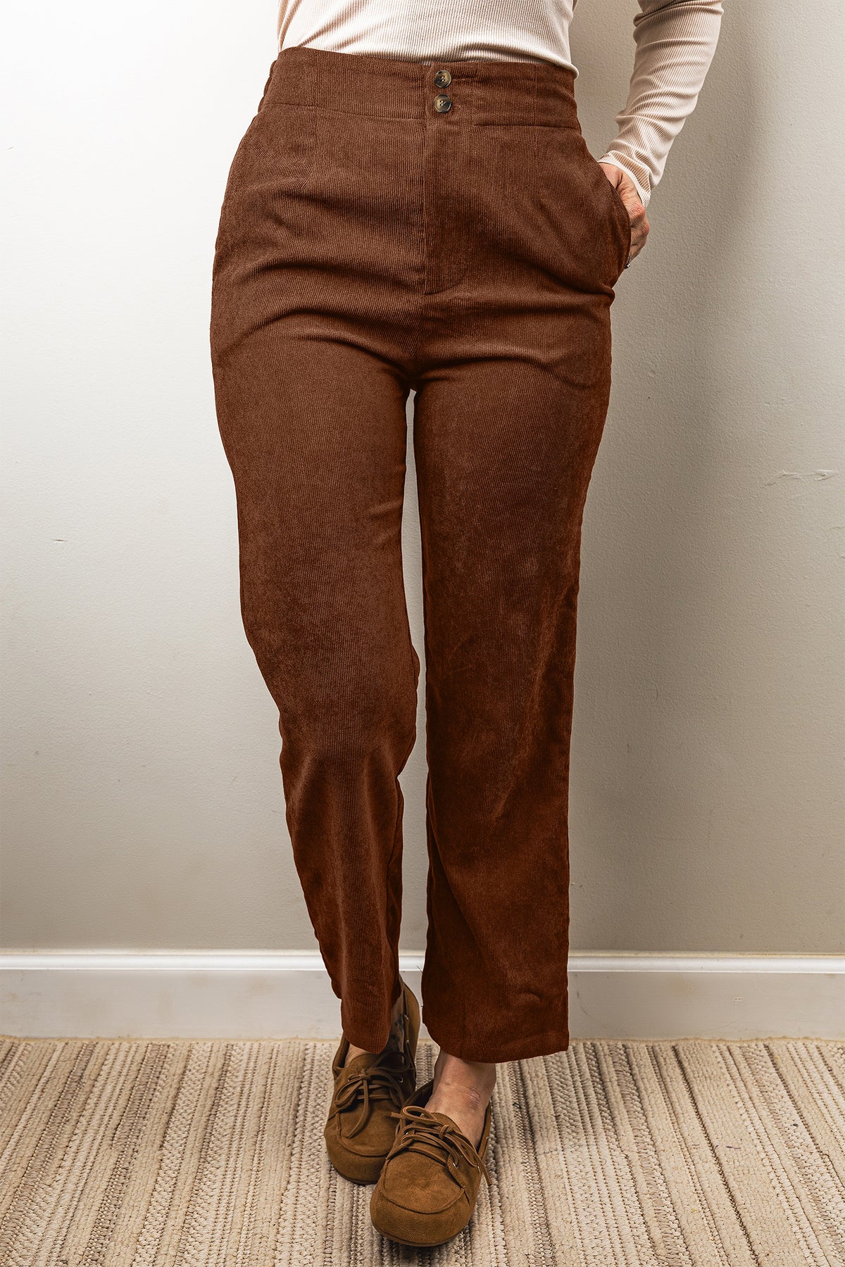 Pantalones de pana color café, de corte recto, largo al tobillo y cintura elástica.