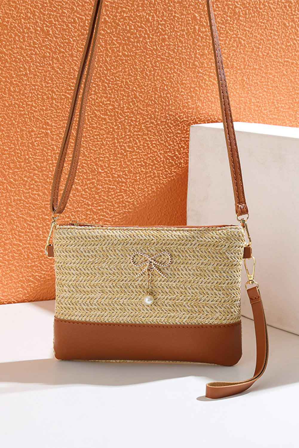 Bolso bandolera de paja y piel sintética con parche, lazo beige y detalle de perlas