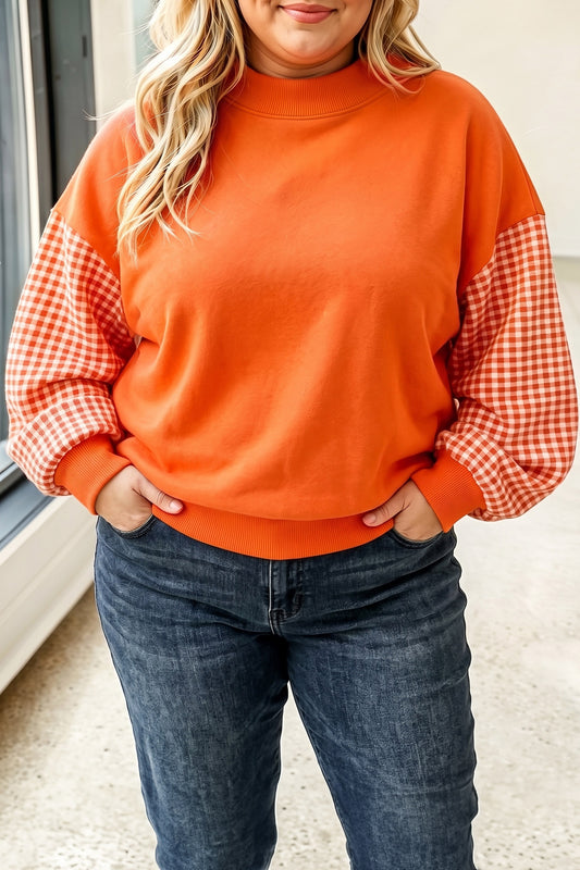 Sudadera de manga larga y corte holgado en tallas grandes, con estampado de cuadros tipo patchwork en tonos naranja rojizo.
